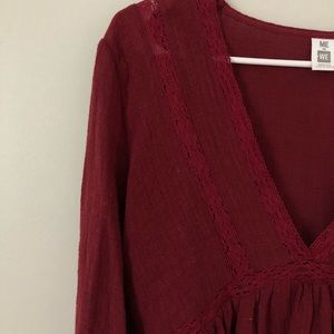 Burgundy/red cropped, ruffled, long sleeve.